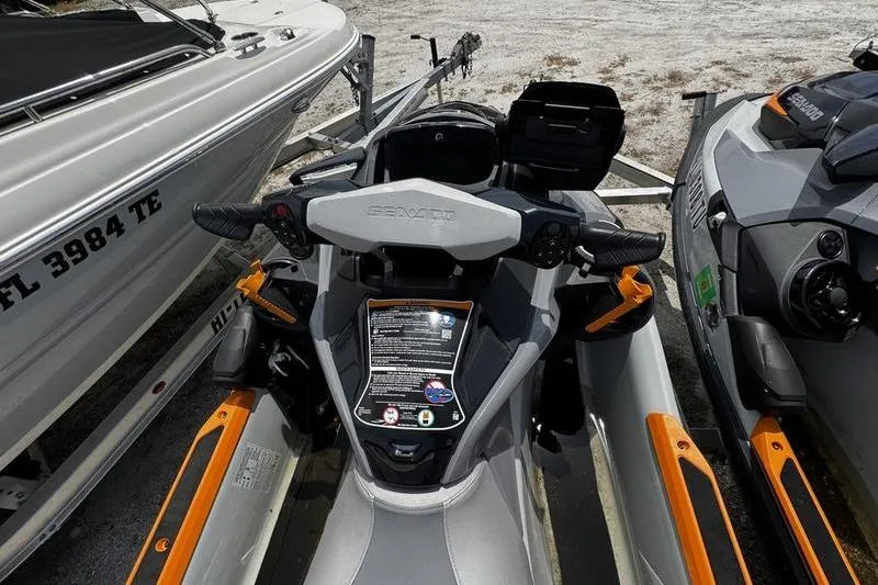 Slide: The Image of 2023 Sea-Doo FishPro Trophy jet ski, parked between boats, showcasing dashboard and controls. - 10