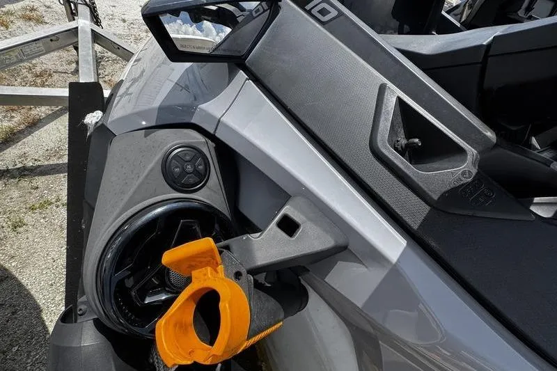 Slide: The Image of 2023 Sea-Doo FishPro Trophy dashboard with orange accessory holder, close-up view. - 11