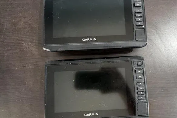 Slide: The Image of Two Garmin marine GPS devices on a dark surface, related to 2023 Sea-Doo FishPro Trophy. - 17