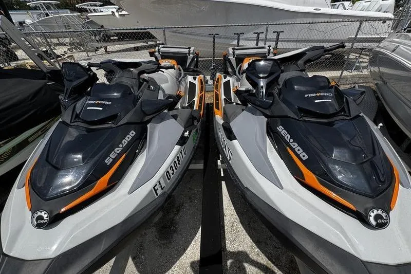 Slide: The Image of 2023 Sea-Doo FishPro Trophy jet skis parked side by side in a marina. - 15