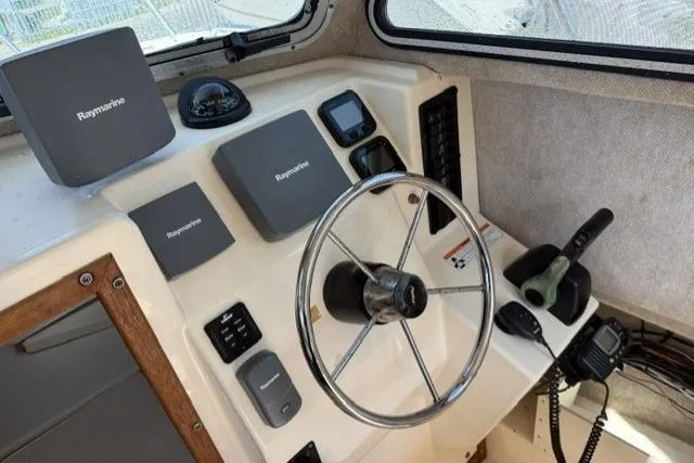 Slide: The Image of Steering console of 2006 Parker 2520 SL Sport Cabin with Raymarine electronics. - 15