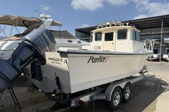 Slide: The Image of 2006 Parker 2520 SL Sport Cabin boat on trailer, Yamaha engine, docked at marina. - 3