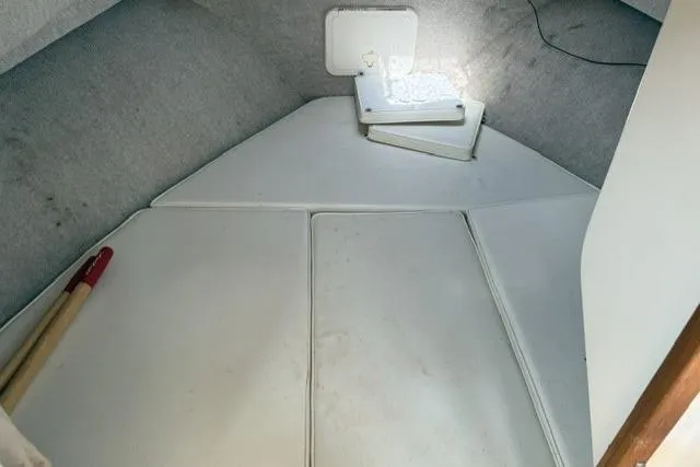 Slide: The Image of Interior cabin of 2006 Parker 2520 SL Sport Cabin boat, featuring cushioned seating. - 16