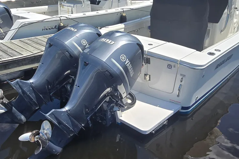 Slide: The Image of 2018 Regulator 28 Forward Seating boat with twin Yamaha 300 engines docked. - 3