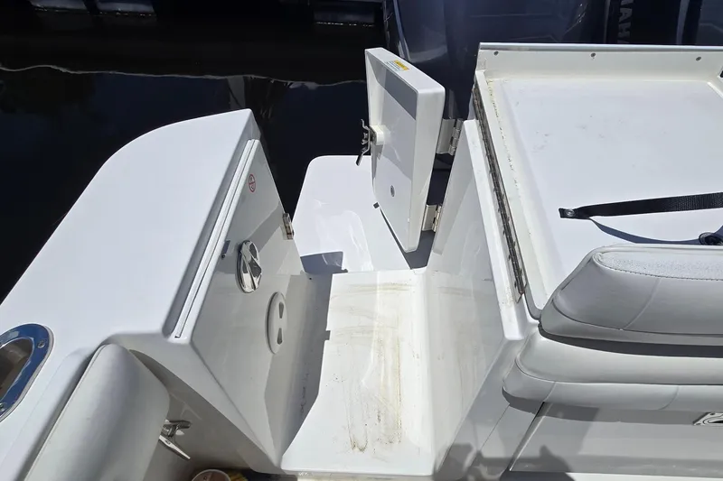 Slide: The Image of 2018 Regulator 28 Forward Seating boat with open hatch and seating area. - 9