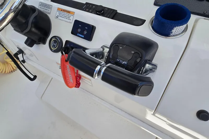 Slide: The Image of Control panel of 2018 Regulator 28 Forward Seating boat with throttle and switches. - 30