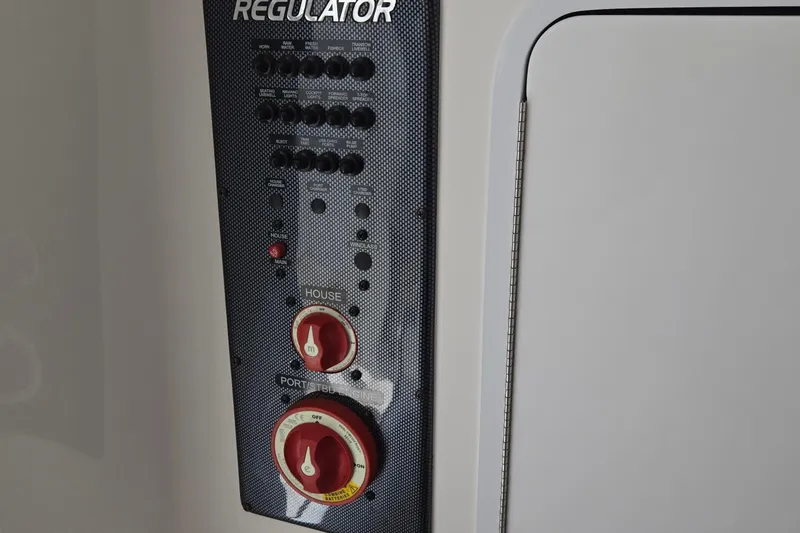 Slide: The Image of Control panel of a 2018 Regulator 28 Forward Seating boat with switches and dials. - 20