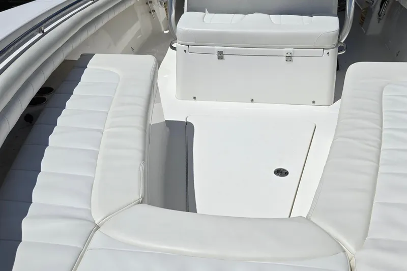 Slide: The Image of 2018 Regulator 28 Forward Seating boat interior with white cushioned seats. - 16