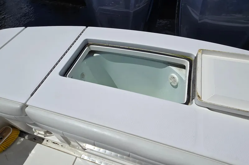 Slide: The Image of Livewell on 2018 Regulator 28 Forward Seating boat, open lid, clean interior. - 27