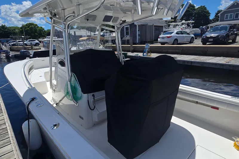 Slide: The Image of 2018 Regulator 28 Forward Seating boat docked at marina under clear blue sky. - 7