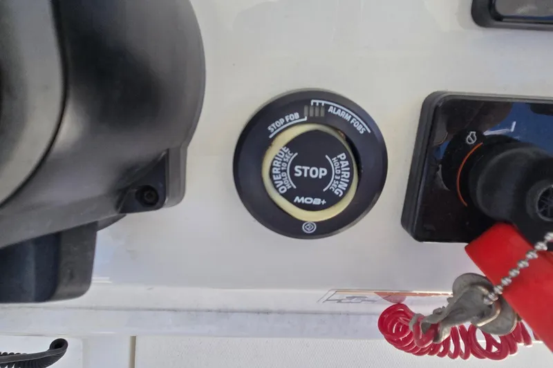 Slide: The Image of Control panel of a 2018 Regulator 28 Forward Seating boat with stop button and safety features. - 31