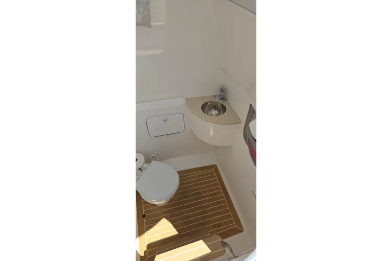Slide: The Image of 2018 Regulator 28 Forward Seating boat interior with toilet and sink. - 18