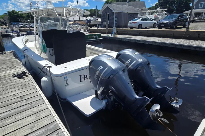 Slide: The Image of 2018 Regulator 28 Forward Seating boat docked with twin Yamaha engines. - 6