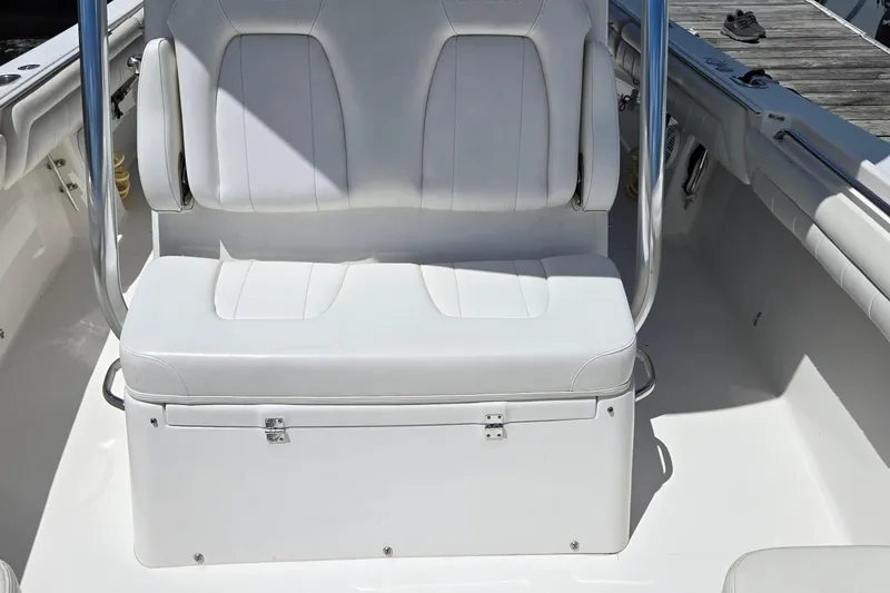 Slide: The Image of 2018 Regulator 28 Forward Seating boat with white cushioned seats and stainless steel accents. - 12
