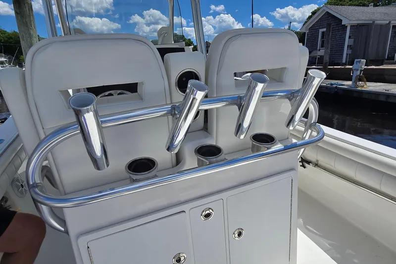 Slide: The Image of 2018 Regulator 28 Forward Seating boat with rod holders and storage compartments. - 28