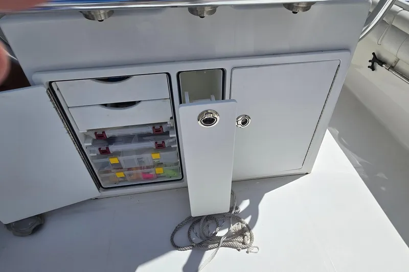 Slide: The Image of 2018 Regulator 28 Forward Seating boat storage with tackle boxes and rope. - 29