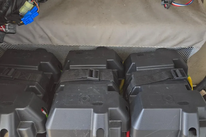 Slide: The Image of Battery compartment of a 2018 Regulator 28 Forward Seating boat, featuring secured battery boxes. - 19