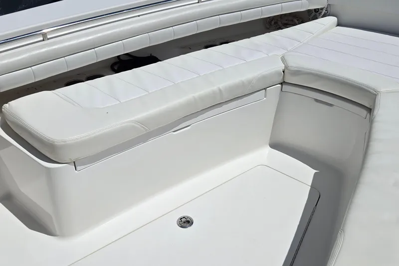 Slide: The Image of 2018 Regulator 28 Forward Seating boat with white cushioned seats. - 11