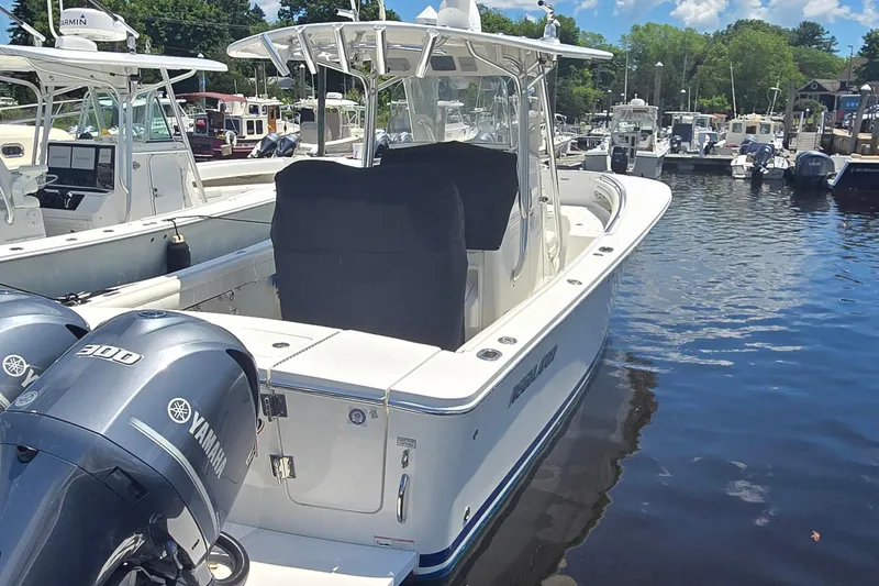 Slide: The Image of 2018 Regulator 28 Forward Seating boat docked with twin Yamaha 300 engines. - 4