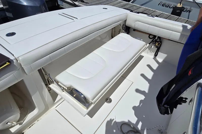 Slide: The Image of 2018 Regulator 28 Forward Seating boat with white cushioned seating and deck details. - 36