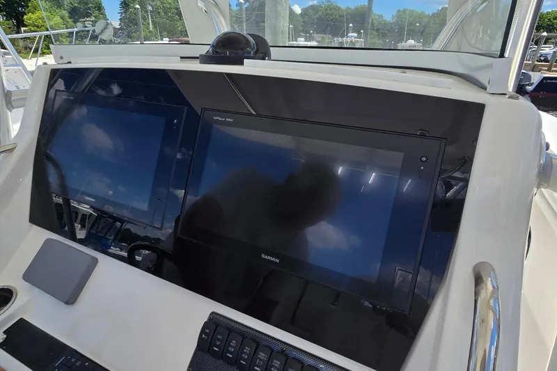 Slide: The Image of 2018 Regulator 28 Forward Seating boat dashboard with dual Garmin displays. - 24