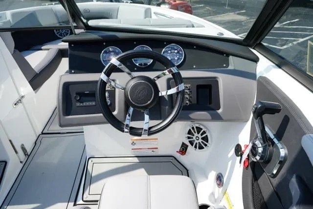 Slide: The Image of 2024 Cobalt CS22 boat dashboard with steering wheel and control panel. - 14