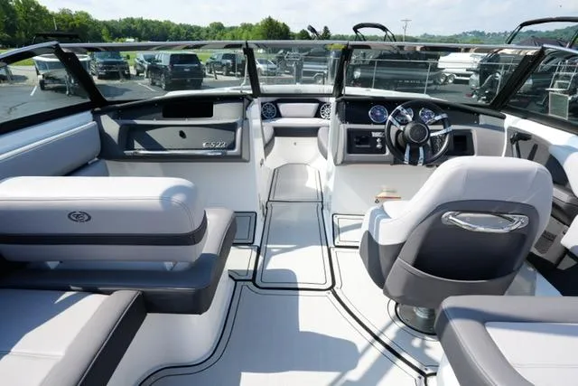 Slide: The Image of 2024 Cobalt CS22 boat interior with modern dashboard and seating, showcasing luxury design. - 12