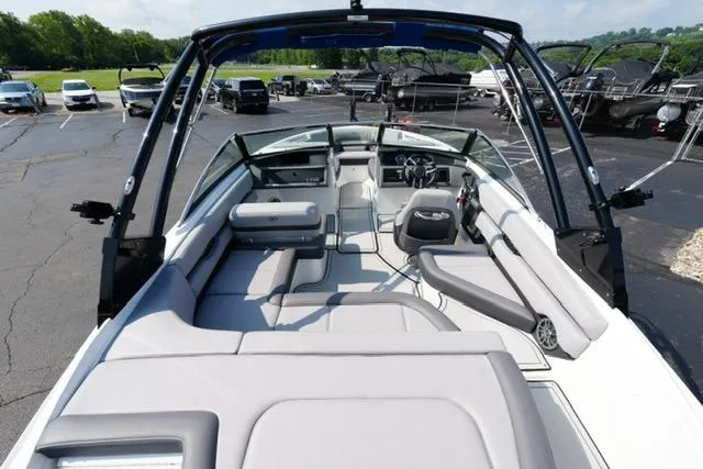 Slide: The Image of 2024 Cobalt CS22 boat interior with spacious seating and modern design in a parking lot. - 8