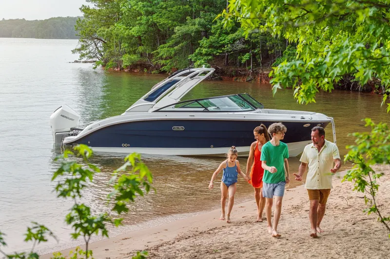 Slide: The Image of A family walks on the beach beside a Sea Ray SDX 250 Outboard boat. - 34