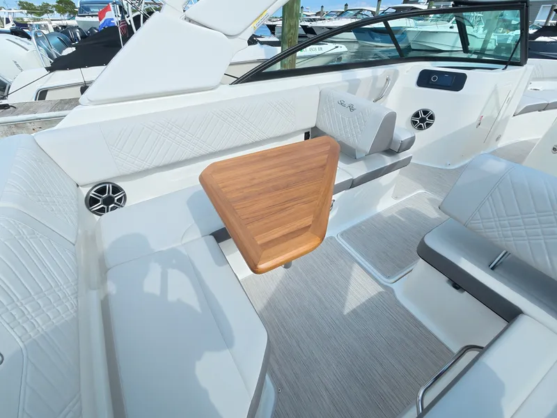 Slide: The Image of The image shows the cockpit of a 2026 Sea Ray SDX 250 Outboard with sleek seating and a wooden table. - 14