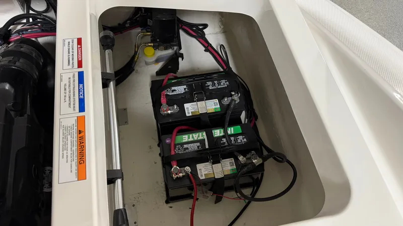 Slide: The Image of Battery compartment of a Sea Ray SPX 210 boat with two batteries and cables. - 35