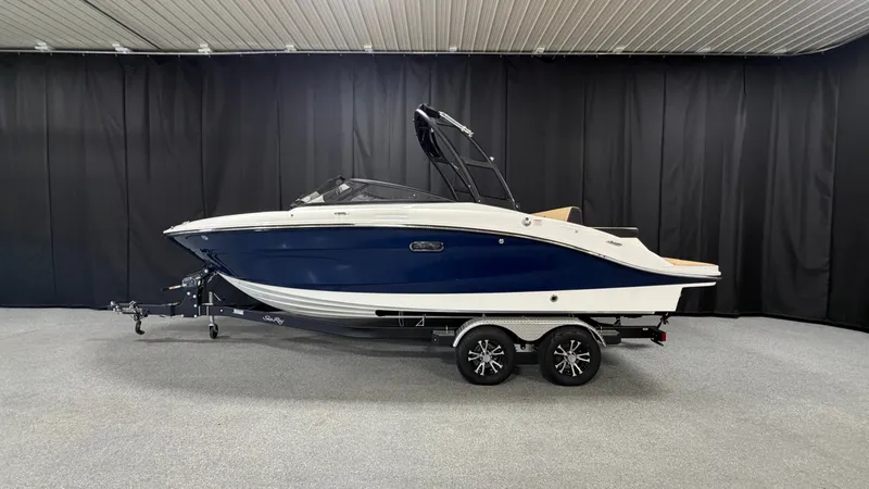 Slide: The Image of A 2027 Sea Ray SPX 210 boat on a trailer in a showroom. - 0