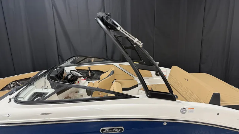 Slide: The Image of A 2027 Sea Ray SPX 210 boat with beige interior and black wakeboard tower. - 5