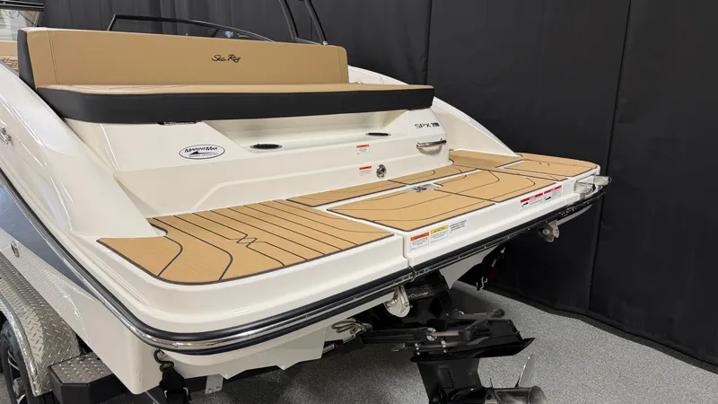 Slide: The Image of The image shows the rear of a 2027 Sea Ray SPX 210 boat with a spacious swim platform. - 8