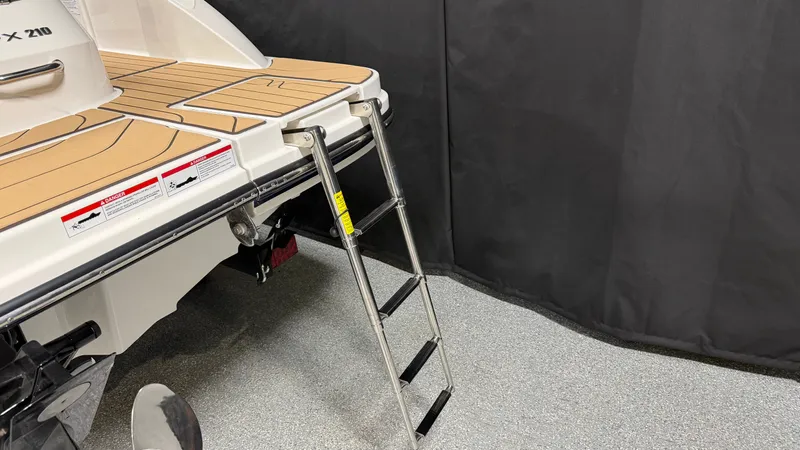 Slide: The Image of The 2027 Sea Ray SPX 210 features a foldable swim ladder at the stern. - 12