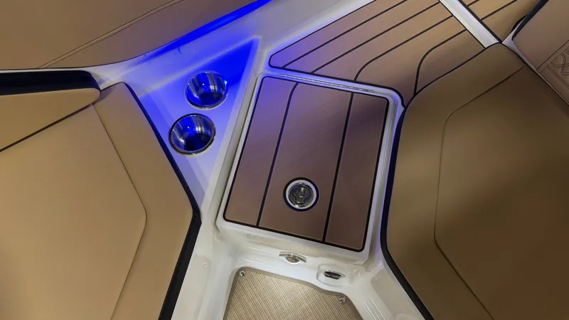 Slide: The Image of The image shows the interior of a Sea Ray SPX 210 boat with sleek seating and blue lighting. - 22