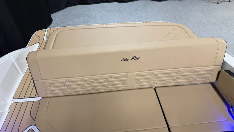 Slide: The Image of The image shows the beige upholstery of a 2027 Sea Ray SPX 210 boat. - 31