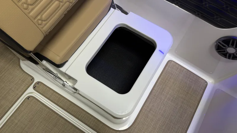 Slide: The Image of An open storage compartment on a boat with cushioned seating and a speaker. - 42