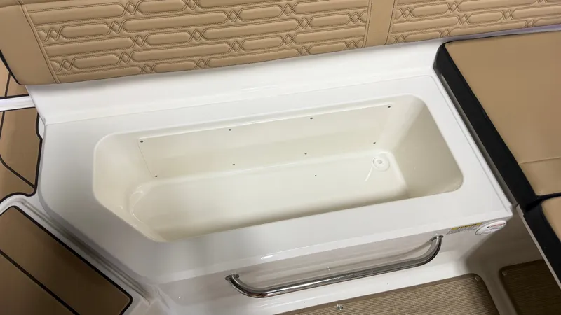 Slide: The Image of Interior of the Sea Ray SPX 210 with beige upholstery and built-in storage. - 28