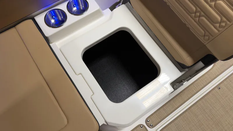 Slide: The Image of An open storage compartment on a Sea Ray SPX 210 boat with two cup holders beside it. - 40
