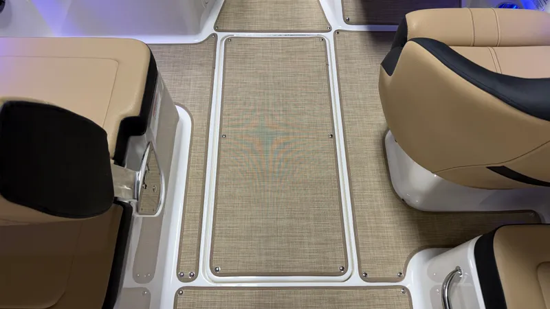 Slide: The Image of Interior of a Sea Ray SPX 210 boat with beige seats and textured flooring. - 48