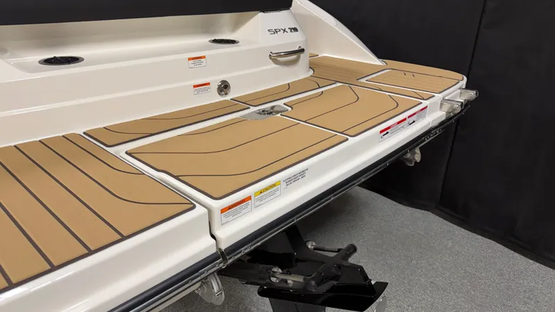 Slide: The Image of The image shows the stern of a Sea Ray SPX 210 boat with a spacious swim platform. - 9