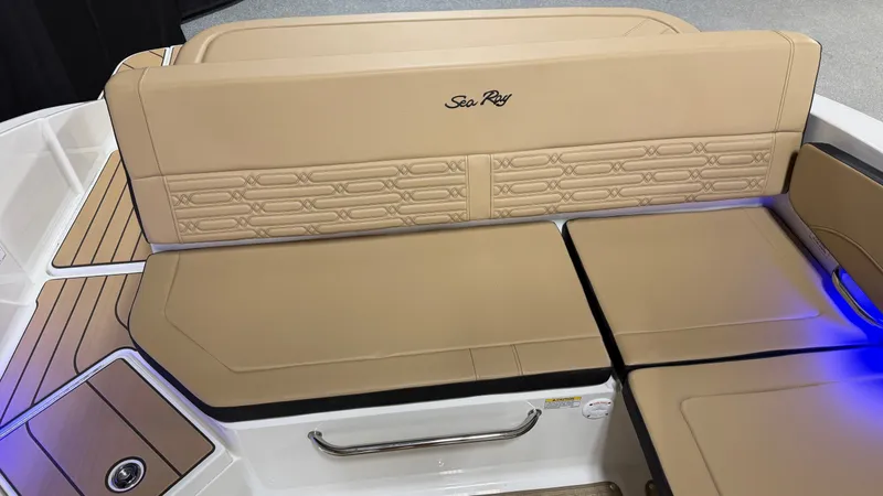 Slide: The Image of The image shows the beige upholstery of a 2027 Sea Ray SPX 210 boat. - 26