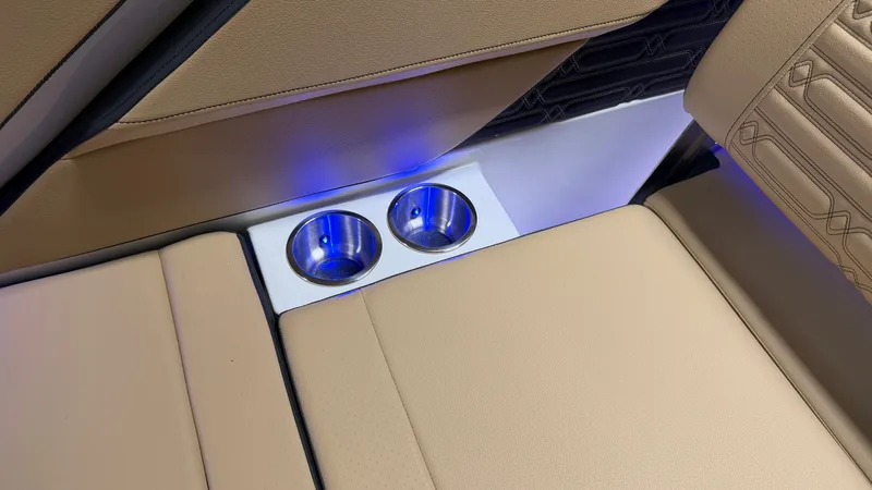 Slide: The Image of The image shows part of a Sea Ray SPX 210 boat interior with two stainless steel cup holders and blue LED lighting. - 39