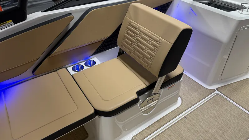 Slide: The Image of The image shows the interior of a Sea Ray SPX 210 boat with beige upholstery and blue lighting. - 38