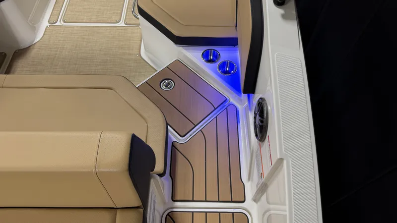 Slide: The Image of Interior of a Sea Ray SPX 210 boat with sleek seating and blue LED lighting. - 18