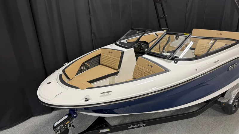 Slide: The Image of A 2027 Sea Ray SPX 210 boat with blue and white exterior and beige seating. - 4