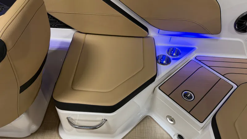 Slide: The Image of The 2027 Sea Ray SPX 210 interior features beige upholstery and blue lighting. - 20
