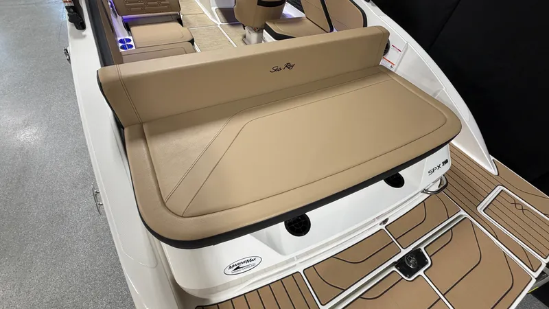 Slide: The Image of The image shows the rear of a Sea Ray SPX 210 boat with a large padded sun deck. - 14