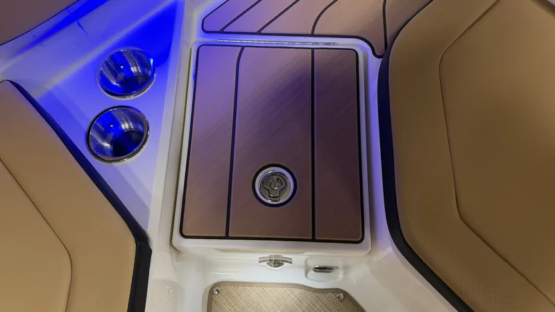 Slide: The Image of Close-up of a Sea Ray SPX 210 cockpit area with blue lighting and cup holders. - 24